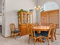Elegant dining room featuring a round table, wooden chairs, and ample natural light at 1536 Goshawk Dr, Longmont, CO 80504