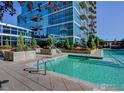 Community pool features pristine blue water and a modern building in the background at 1700 Bassett St # 903, Denver, CO 80202