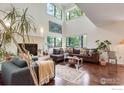 Bright living room with hardwood floors, fireplace, soaring ceilings, and large windows with scenic views at 2617 Juniper Ave, Boulder, CO 80304