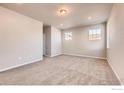 Comfortable bedroom boasts neutral walls, plush carpeting, and natural light from large windows at 2718 Crystal Springs Ln, Longmont, CO 80503