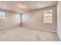 Spacious bedroom has neutral walls, plush carpeting and multiple windows overlooking the neighborhood at 2718 Crystal Springs Ln, Longmont, CO 80503