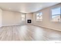 Bright living room featuring wood floors, a fireplace, and plenty of natural light at 2718 Crystal Springs Ln, Longmont, CO 80503