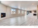Spacious living room with fireplace, hardwood floors, and ample natural light from the large windows at 2718 Crystal Springs Ln, Longmont, CO 80503