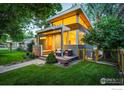 Architecturally unique home with large windows, modern design, complemented by green lawn and mature trees at 2750 7Th St, Boulder, CO 80304