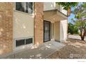 Front entrance of building featuring door with security gate and a covered overhang at 2835 S Monaco Pkwy # 104, Denver, CO 80222