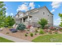 Beautiful home with a covered porch and lush landscaping at 3075 Blue Mountain Dr, Broomfield, CO 80023