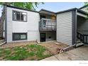 Exterior shot of a two-story condo with neutral siding, a small yard, and a private balcony at 3255 34Th St # 42, Boulder, CO 80301