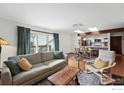 Open-concept living room with hardwood floors, modern furnishings, and a view to the kitchen at 3255 34Th St # 42, Boulder, CO 80301
