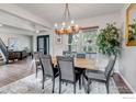 Traditional dining room featuring an elegant chandelier and a view of the home's front yard at 5111 Mt St Vrain Ave, Frederick, CO 80504
