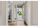 Bright foyer with hardwood floors and a view of the home's exterior at 767 Cabot Dr, Erie, CO 80516