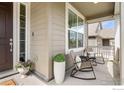 Cozy front porch featuring comfortable seating, stylish decor, and a welcoming entrance at 767 Cabot Dr, Erie, CO 80516