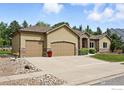Charming single-story home with a three-car garage, landscaped yard, and stone accents on the facade at 10882 Legacy Ridge Way, Westminster, CO 80031