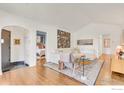 Bright living room featuring hardwood floors, white walls, and a view into the bedroom at 1226 Dexter St, Denver, CO 80220