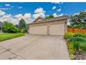 Spacious three-car garage with ample parking and a well-maintained driveway at 13112 Summit Grove Pkwy, Thornton, CO 80241