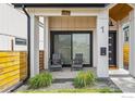 Inviting front porch with seating area and modern house number display at 1578 Lowell Blvd # 1, Denver, CO 80204