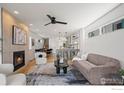 Open-concept living area with a cozy fireplace, modern furnishings, and sleek finishes at 1578 Lowell Blvd # 1, Denver, CO 80204