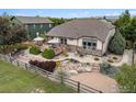 A gorgeous backyard with a deck, stone patio, and meticulous landscaping at 1826 Lochmore Dr, Longmont, CO 80504