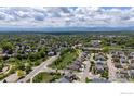 Expansive aerial view showcasing neighborhood, landscaping, and mountain backdrop at 2211 Winding Dr, Longmont, CO 80504