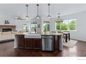 Bright kitchen featuring stainless steel appliances, island, and farmhouse sink at 2211 Winding Dr, Longmont, CO 80504