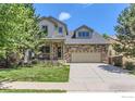 Charming two-story home featuring a stone and siding exterior, well-maintained landscaping, and a covered porch at 2312 Dogwood Dr, Erie, CO 80516