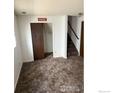Finished basement with carpet, closet, and access to the stairs at 2449 Linden St, Longmont, CO 80501