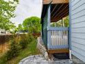 Wooden deck with gray trim overlooking landscaped yard and stone patio at 2720 E 121St Pl, Thornton, CO 80241