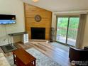Spacious living room featuring a fireplace and sliding glass doors to a private deck at 2855 Shadow Creek Dr # 302, Boulder, CO 80303