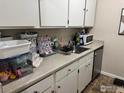 A well-maintained kitchen with white cabinets and stainless steel appliances, perfect for cooking at 3623 S Sheridan Blvd # 11, Lakewood, CO 80235