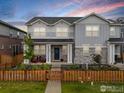 Charming two-story home with stone accents, covered porch, and a well-manicured lawn at 364 Fickel Farm Trl, Berthoud, CO 80513