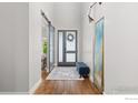 Bright entryway with wood floors, modern light fixture, and stylish barn door at 3681 Paonia St, Boulder, CO 80301