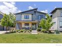 Stunning modern home with stone accents, a welcoming porch, and beautifully landscaped front yard at 3681 Paonia St, Boulder, CO 80301