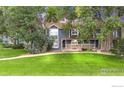 Charming two-story townhome with stone accents and a well-manicured lawn at 3807 Paseo Del Prado, Boulder, CO 80301