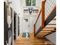 Bright foyer with hardwood floors, contemporary art, and a modern staircase at 404 W Cleveland St, Lafayette, CO 80026