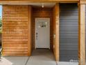 Contemporary home featuring a wood plank facade entrance with a white front door at 404 W Cleveland St, Lafayette, CO 80026