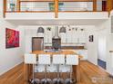Modern kitchen with an island and seating, stainless steel appliances and custom cabinets at 404 W Cleveland St, Lafayette, CO 80026