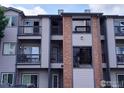 Condo with private balcony, gray siding, and red brick at 50 19Th Ave, Longmont, CO 80501