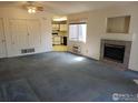 Inviting living room with fireplace, neutral walls, plush carpeting, and natural light at 50 19Th Ave, Longmont, CO 80501
