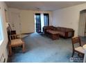Living room featuring gray carpet, a sliding glass door, and lots of natural light at 50 19Th Ave, Longmont, CO 80501