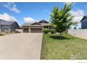 A beautifully landscaped home boasts a three-car garage and welcoming entrance at 5869 Vinca Ave, Longmont, CO 80504