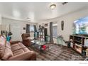 Bright living room offering a comfortable seating area with large sofa, recliner, and modern décor at 6743 King St, Denver, CO 80221