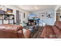 Inviting living room space with large sofa, recliner, telescope, and stylish decor at 6743 King St, Denver, CO 80221