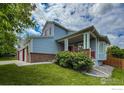 Two-story home featuring a cozy front porch, light blue siding, and brick accents at 678 Mcclure Ct, Erie, CO 80516