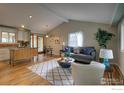 Bright living room featuring hardwood floors, modern furnishings, and vaulted ceiling at 1110 Hartford Dr, Boulder, CO 80305