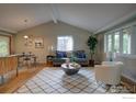 Bright living room featuring hardwood floors, modern furnishings, and vaulted ceiling at 1110 Hartford Dr, Boulder, CO 80305