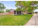 A charming single story brick home with a covered porch and large grassy front lawn at 11385 Downing Dr, Northglenn, CO 80233