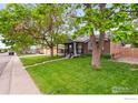 Single story home with covered porch, beautiful lawn and mature trees at 11385 Downing Dr, Northglenn, CO 80233