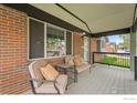 Inviting covered front porch with seating, perfect for relaxing outdoors at 11385 Downing Dr, Northglenn, CO 80233