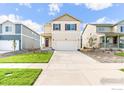Charming suburban home with a 2-car garage, neutral siding, maroon-colored shutters, and a well-manicured lawn at 1638 Plata St, Lochbuie, CO 80603