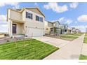 New suburban construction with a 2-car garage, manicured lawn, and sidewalks at 1638 Plata St, Lochbuie, CO 80603