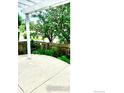 A spacious concrete patio bordered by lovely flower beds and a wooden fence at 1847 White Feather Dr, Longmont, CO 80504